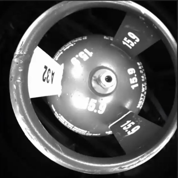 A hard to read case: Reflections off a a new and shiny cylinder.