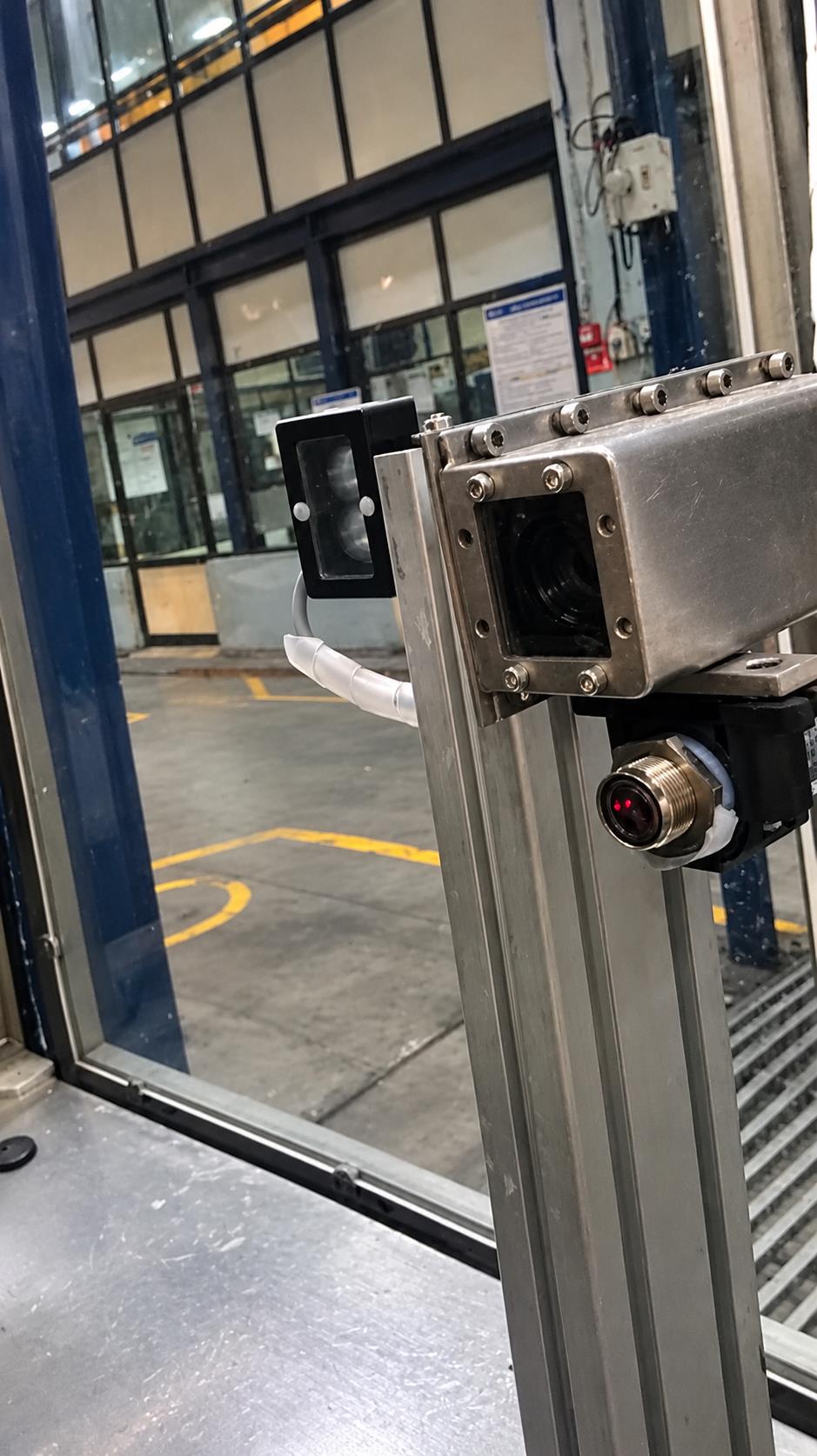 Camera and protected illumination assembly at the bottle-label inspection station
