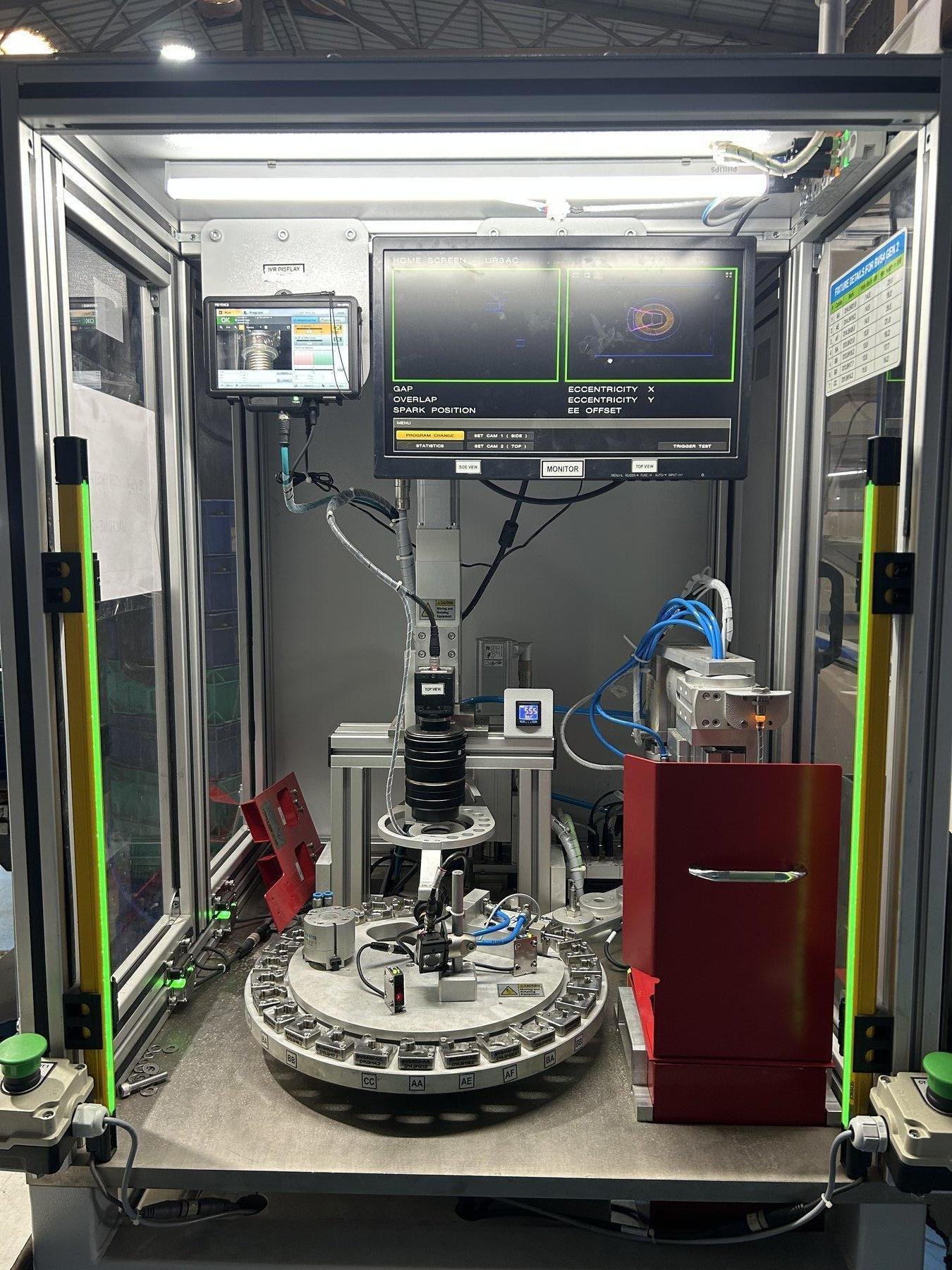 Rotary inspection cell with camera stations, part fixtures and operator displays.
