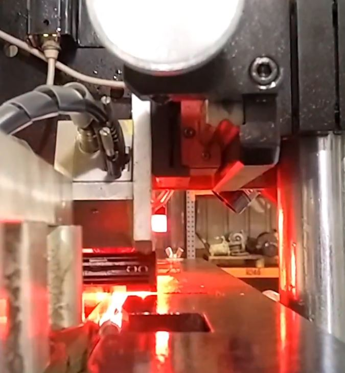Cameras and controlled red illumination around the roller path.