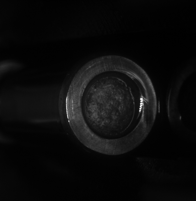 The larger end face, viewed separately from the curved surface.